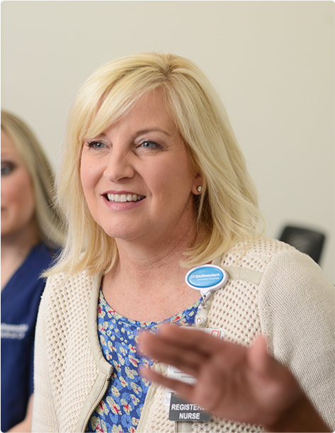 Smiling woman sitting and listening to an employee presentation